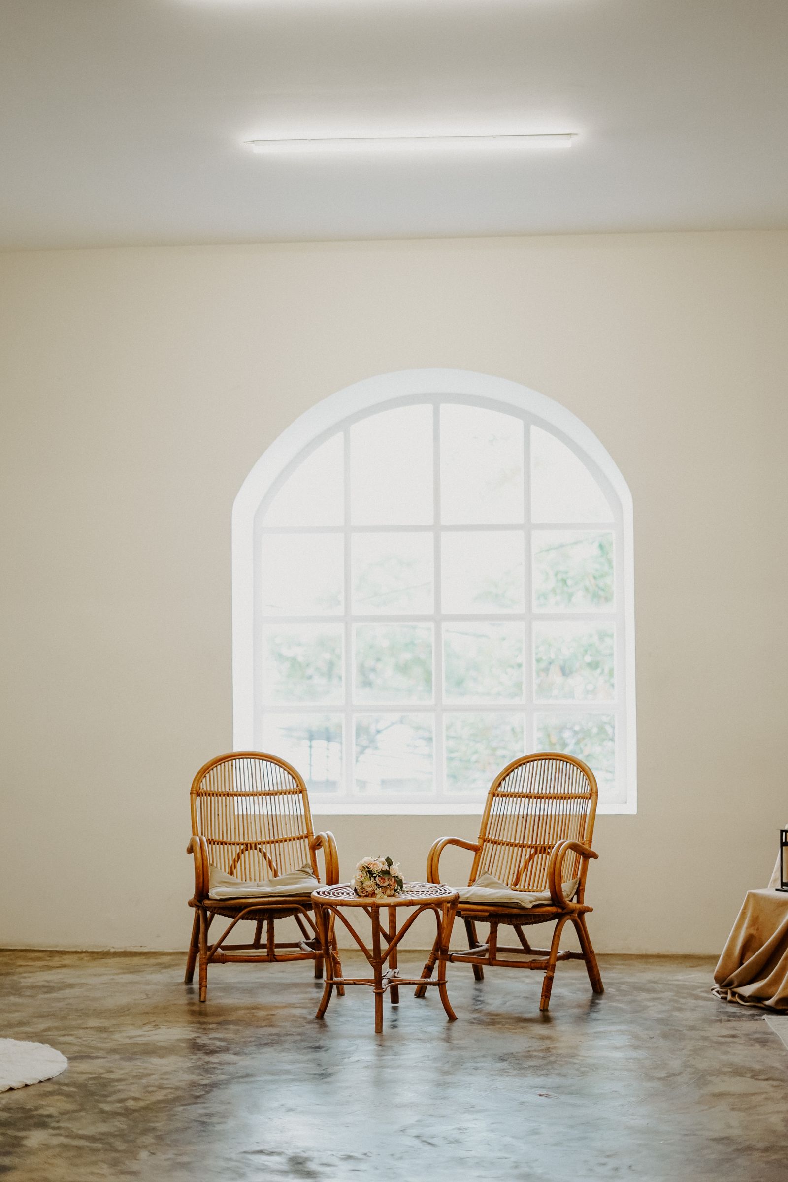 Rattan chair and woven furniture in a simple, light-filled room
