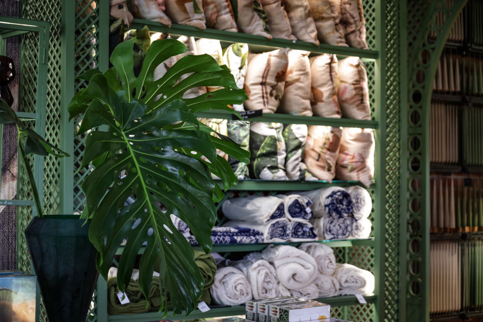 Upscale retail interior with green decor and displayed textiles