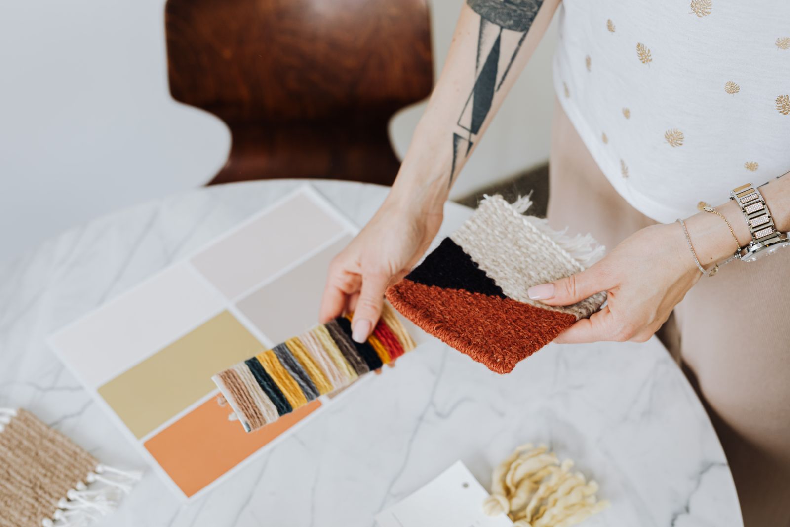 Woman comparing paint chips and material samples at a work table